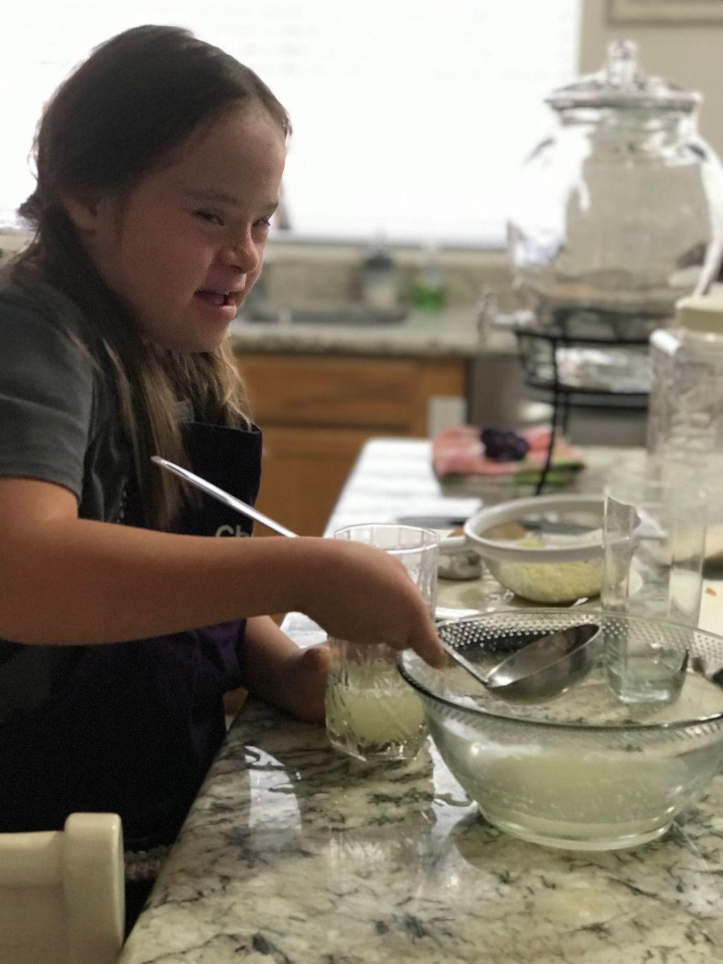 A child learning making punch